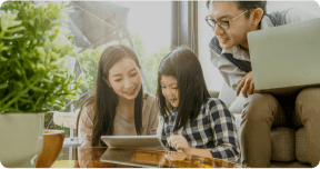 Asian family look at at computer together